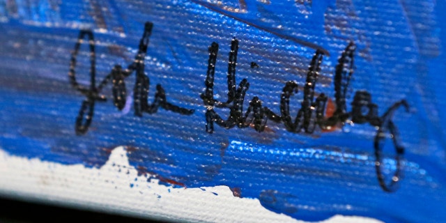 In this photo taken March 18, 2015, the signature on a painting by John Hinkley is seen in Hampton, Va. (AP Photo/Steve Helber)