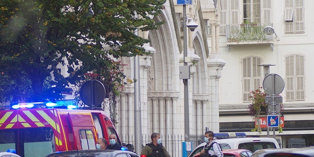 French policemen stand next to Notre Dame church after a knife attack, in Nice, France, Thursday, Oct. 29, 2020. French anti-terrorism prosecutors are investigating a knife attack at a church in the Mediterranean city of Nice that killed three people and injured several others. (AP Photo/Alexis Gilli)