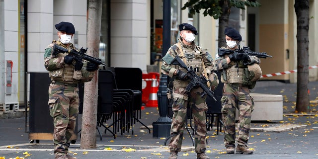 Soldiers patrol near Notre Dame church in Nice, southern France, on Thursday after an attacker armed with a knife killed three people at a church. (Eric Gaillard / Pool via AP)