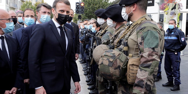 French President Emmanuel Macron, center, meets soldiers after a knife attack at Notre Dame church in Nice, southern France, Thursday, Oct. 29, 2020. (Eric Gaillard/Pool via AP)