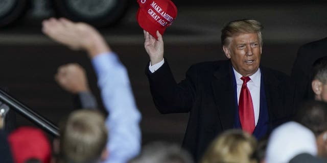 FILE - In this Sept. 17, 2020 file photo President Donald Trump throws a hat to the crowd after speaking at a campaign rally at the Central Wisconsin Airport in Mosinee, Wis. (AP Photo/Morry Gash, File)