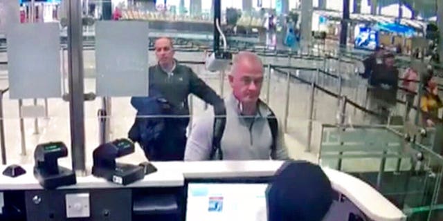 This Dec. 30, 2019 image from security camera video shows Michael L. Taylor, center, and George-Antoine Zayek at passport control at Istanbul Airport in Turkey. (DHA via AP)