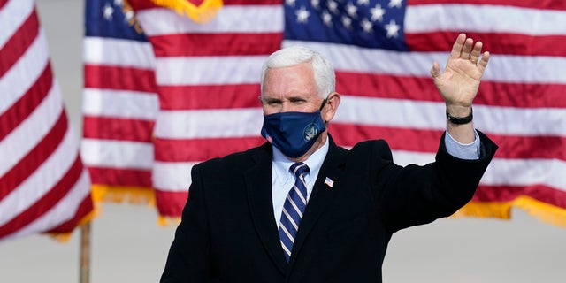 Vice President Mike Pence wears a face mask as he arrives for an airport rally, Thursday, Oct. 29, 2020, in Des Moines, Iowa. (AP Photo/Charlie Neibergall)