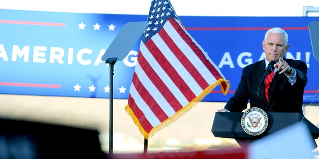 Vice President Mike Pence gestures at a campaign rally at Reno-Tahoe International Airport in Reno, Nev., Thursday, Oct. 29, 2020. (AP Photo/Lance Iversen)