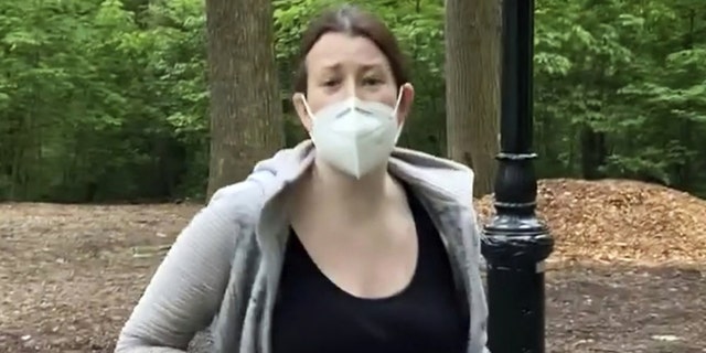 This image from a May 25, 2020, video provided by Christian Cooper, shows Amy Cooper with her dog talking to Christian Cooper in Central Park in New York City. Amy Cooper called the police during a videotaped dispute with Christian Cooper, a Black man, to claim he was threatening her. (Associated Press)