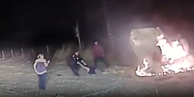Footage from Cpl. Pheng Ly's rescue of a woman who was trapped inside a burning car (Davis Police Department via. FOX40)