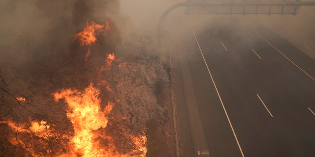 The Silverado Fire burns along the 241 State Highway Monday, Oct. 26, 2020, in Irvine, Calif.