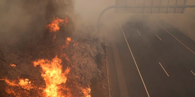 The Silverado Fire burns along the 241 State Highway Monday, Oct. 26, 2020, in Irvine, Calif.