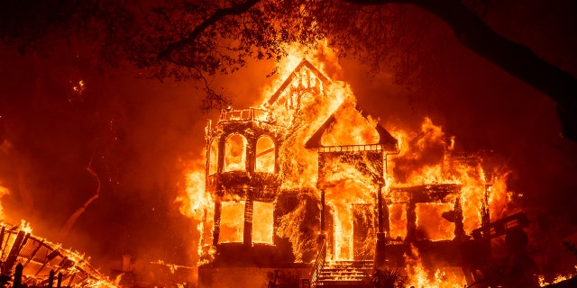 Flames from the Glass Fire consume the Black Rock Inn, late Sunday, Sept. 27, 2020, in St. Helena, Calif.