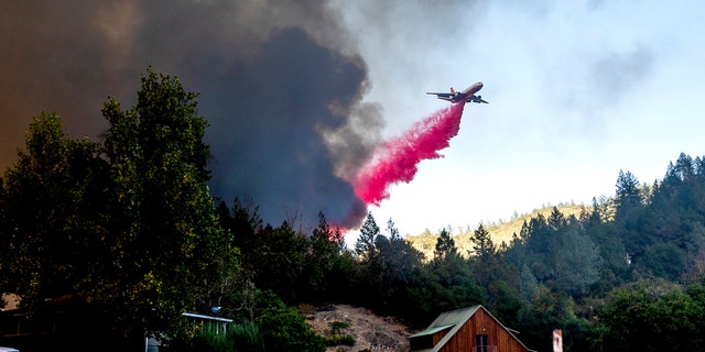 An air tanker drops retardant while battling the Glass Fire in St. Helena, Calif., on Sunday, Sept. 27, 2020.
