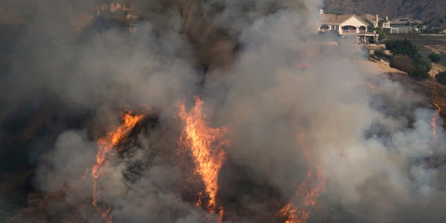 The Blue Ridge Fire burns near homes Tuesday, Oct. 27, 2020, in Yorba Linda, Calif.