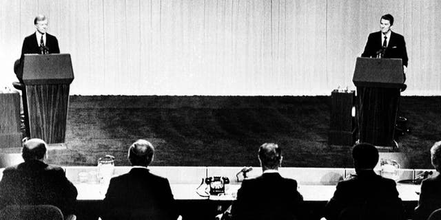 U.S. President Jimmy Carter, left, and Republican presidential candidate Ronald Reagan face their panelists during their televised debate at the Cleveland Convention Center in Cleveland, Ohio, on Oct. 28, 1980. (AP Photo)