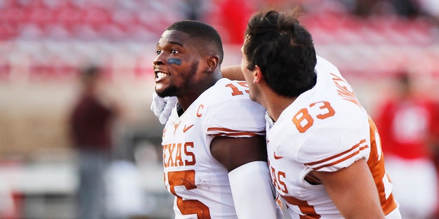 Texas defensive back Chris Brown and wide receiver Kai Money celebrate their win over Texas Tech after an NCAA college football game against Texas Tech, Saturday, Sept. 26, 2020, in Lubbock, Texas. (AP Photo/Mark Rogers)