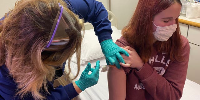 A 16-year-old patient receives a dose of Pfizer's coronavirus vaccine candidate at the Cincinnati Children's Hospital. (Photo courtesy of Cincinnati Children’s)