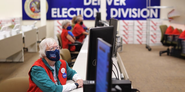 FILE Photo: Election judge Mary Ann Thompson, front, is checking ballots at adjudication section at the Denver Elections Division in Denver, Colorado on Thursday, October 29, 2020. 