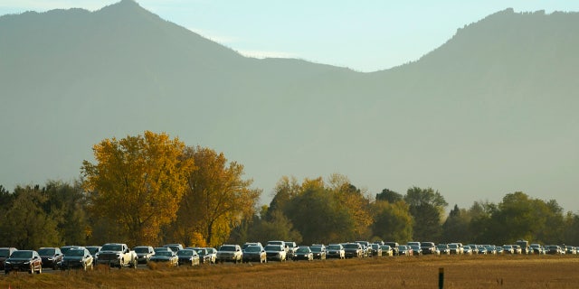 Smoke from several wildfires burning in the state obscures the mountains as traffic backs up on northbound Highway 119 late Wednesday, Oct. 21, 2020, in Boulder, Colo.
