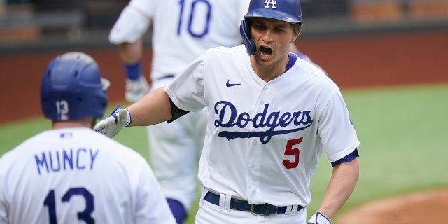 Los Angeles Dodgers' Corey Seager celebrates his home run against the Atlanta Braves during the first inning in Game 6 of a baseball National League Championship Series Saturday, Oct. 17, 2020, in Arlington, Texas. (AP Photo/Eric Gay)