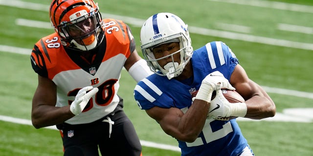 Indianapolis Colts's DeMichael Harris runs against Cincinnati Bengals' LeShaun Sims (38) during the second half of an NFL football game, Sunday, Oct. 18, 2020, in Indianapolis. (AP Photo/Michael Conroy)