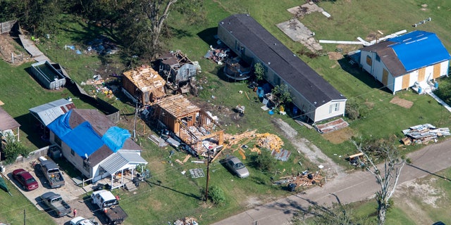 Blue tarps cover houses in the aftermath of Hurricane Delta, Saturday Oct. 10, 2020, in Lake Arthur, La. (Bill Feig/The Advocate via AP, Pool)