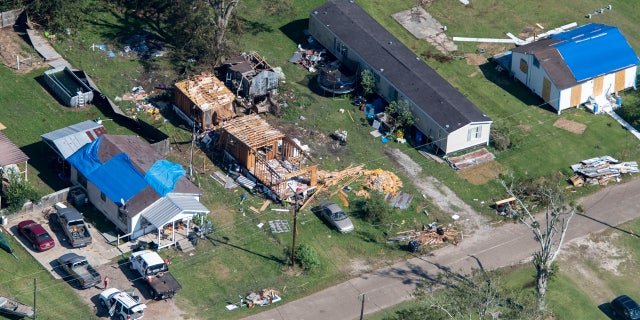 Blue tarps cover houses in the aftermath of Hurricane Delta, Saturday Oct. 10, 2020, in Lake Arthur, La. (Bill Feig/The Advocate via AP, Pool)
