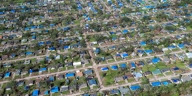 Blue tarps cover houses in the aftermath of Hurricane Delta, Saturday Oct. 10, 2020, in Lake Charles, La.