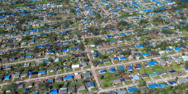 Blue tarps cover houses in the aftermath of Hurricane Delta, Saturday Oct. 10, 2020, in Lake Charles, La.