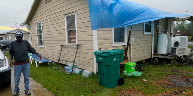 Ernest Jack moves near his home that was hit by Hurricane Laura ahead of Hurricane Delta, Friday, Oct. 9, 2020, in Lake Charles, La.