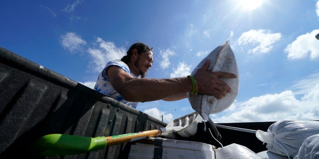 Residents fill sandbags to protect their home in anticipation of Hurricane Delta, expected to arrive along the Gulf Coast later this week, in Houma, La., Wednesday, Oct. 7, 2020.