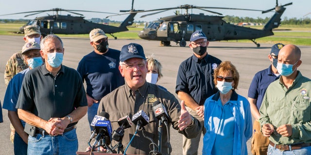 Louisiana Gov. John Bel Edwards talks about the devastation from Hurricane Delta after flying over the stricken areas in southwest Louisiana during a press conference at the airport Saturday Oct. 10, 2020, in Jennings, La.