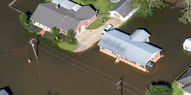 Houses surrounded by flood waters are seen in the aftermath of Hurricane Delta Saturday Oct. 10, 2020, in Welsh, La.