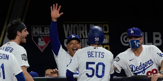 Dodgers celebrate Mookie Betts' go-ahead run. (AP Photo/Tony Gutierrez)