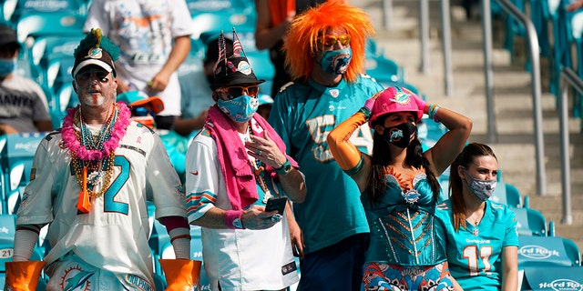 Miami Dolphins fans react as the team falls further behind during the second half of an NFL football game against the Seattle Seahawks, Sunday, Oct. 4, 2020 in Miami Gardens, Fla. The Seahawks defeated the Dolphins 31-23.(AP Photo/Wilfredo Lee)