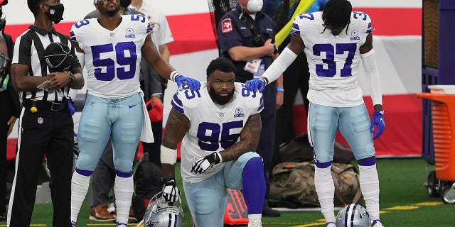 Dallas Cowboys defensive tackle Dontari Poe (95) kneels during the national anthem prior to the game against the Atlanta Falcons at AT&amp;T Stadium. (Matthew Emmons-USA TODAY Sports)