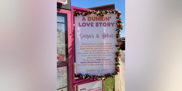 A sign posted near the drive-thru menu welcomed locals to come celebrate the wedding with a free doughnut.