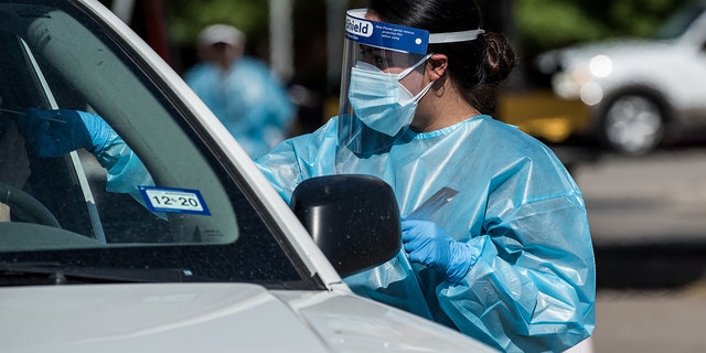A nurse conducts a coronavirus test at a drive-thru site in El Paso, Texas, July 21, 2020. (Getty Images)