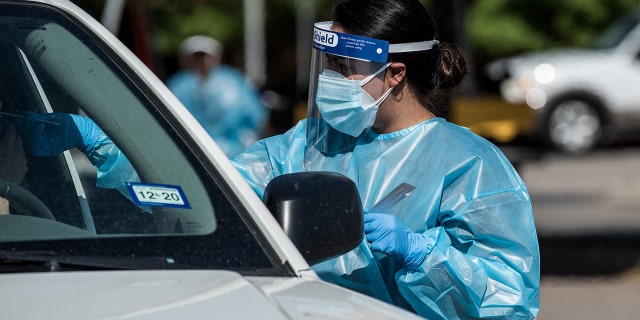 A nurse conducts a coronavirus test at a drive-thru site in El Paso, Texas, July 21, 2020. (Getty Images)