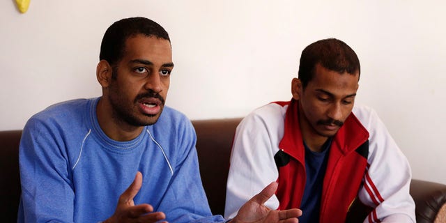 FILE - In this March 30, 2019, file photo, Alexanda Amon Kotey, left, and El Shafee Elsheikh, who were allegedly among four British jihadis who made up a brutal Islamic State cell dubbed "The Beatles," speak during an interview with The Associated Press at a security center in Kobani, Syria. (AP Photo/Hussein Malla, File)
