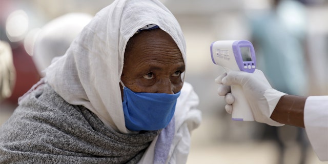 Officials take Lideta Church visitors' temperature as a precaution against the novel coronavirus (Covid-19) pandemic in Addis Ababa, Ethiopia on June 9. (Photo by Minasse Wondimu Hailu/Anadolu Agency via Getty Images)