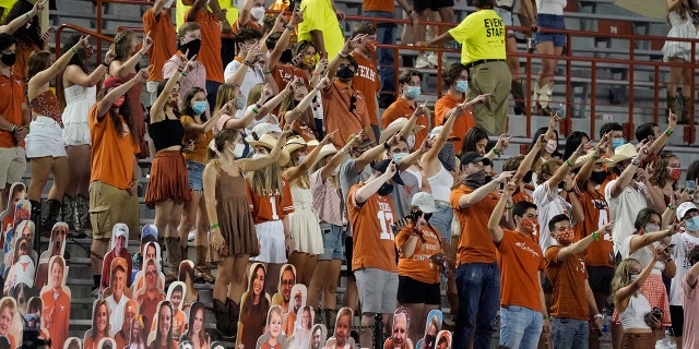In this Saturday, Sept. 12, 2020, file photo, fans join in singing "The Eyes of Texas" after Texas defeated UTEP 59-3 in an NCAA college football game in Austin, Texas. (AP Photo/Chuck Burton, File)