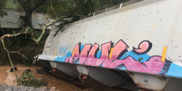 Georgia train derailment sparks fire after Delta unleashes flash flooding, tornadoes across South 4 A freight train derailed early Sunday in Lilburn, Ga., sparking a small fire and triggering evacuations in one neighborhood.