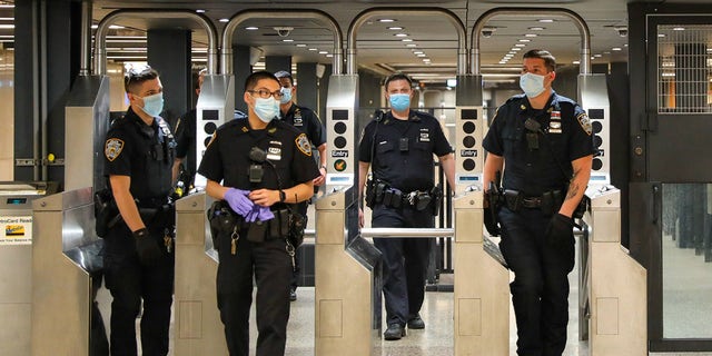 FILE PHOTO: Police officers on patrol around Times Square subway station on May 15, 2020 in New York City.  