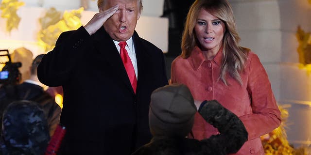US President Donald Trump and first lady Melania Trump greet a trick-or-treater. (Olivier Douliery/AFP via Getty Images)