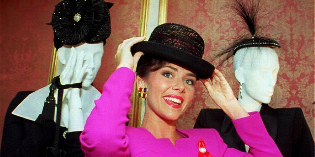 Miss America 1993 Leanza Cornett tries on a hat in New York.