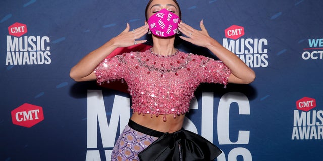 Sarah Hyland wears a mask with the word 'VOTE' written on it multiple times. (Photo by Rich Fury/CMT2020/Getty Images for CMT)