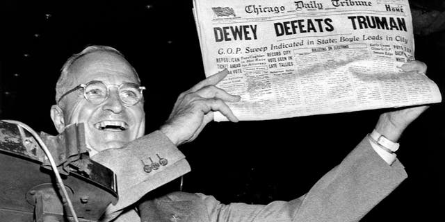 President Harry Truman holds up a copy of the Chicago Daily Tribune wrongly declaring his defeat to Thomas Dewey in the presidential election, St Louis, MIssouri, November 1948. (Photo by Underwood Archives/Getty Images)