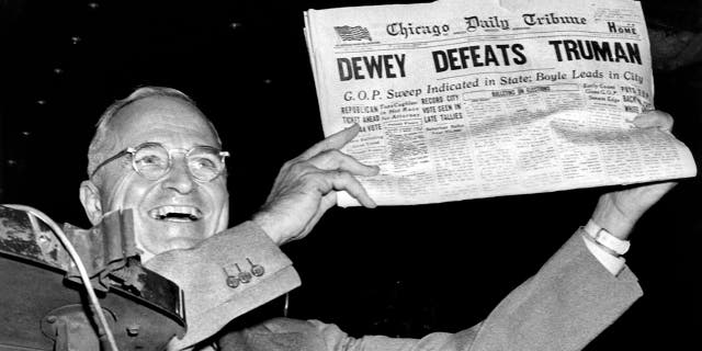 President Harry Truman holds up a copy of the Chicago Daily Tribune declaring his defeat to Thomas Dewey in the presidential election, in St. Louis, Missouri, November 1948. 