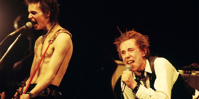 Sid Vicious (left) and Johnny Rotten (John Lydon) performing live on stage at The Great South East Music Hall &amp; Emporium.