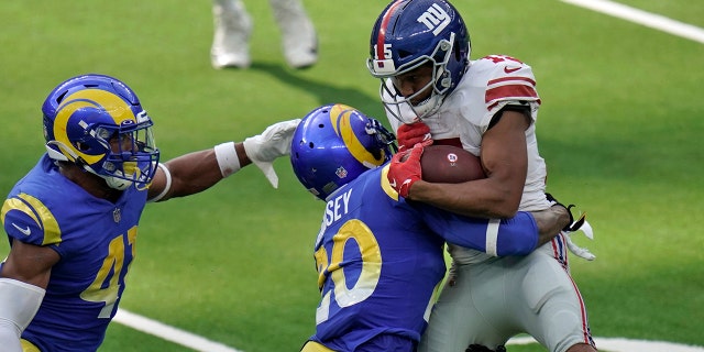New York Giants wide receiver Golden Tate, right, is tackled by Los Angeles Rams cornerback Jalen Ramsey, center, during the second half of an NFL football game Sunday, Oct. 4, 2020, in Inglewood, Calif. (AP Photo/Jae C. Hong)