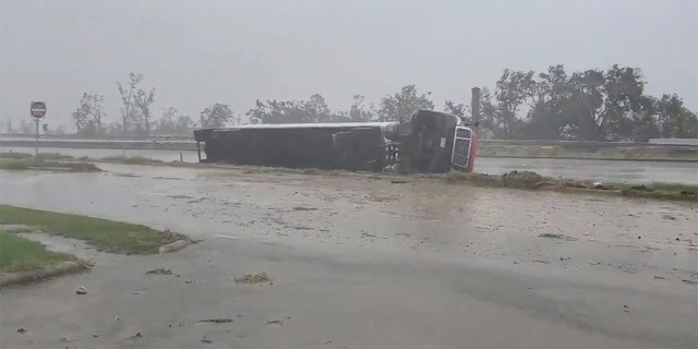 A truck flipped on its side due to winds from Hurricane Delta is seen at Lake Charles, Louisiana, U.S., October 9, 2020, in this still image from video obtained via social media. Adam Fields via REUTERS ATTENTION EDITORS - THIS IMAGE HAS BEEN SUPPLIED BY A THIRD PARTY. MANDATORY CREDIT. NO RESALES. NO ARCHIVES. - RC2DFJ9PHEVJ