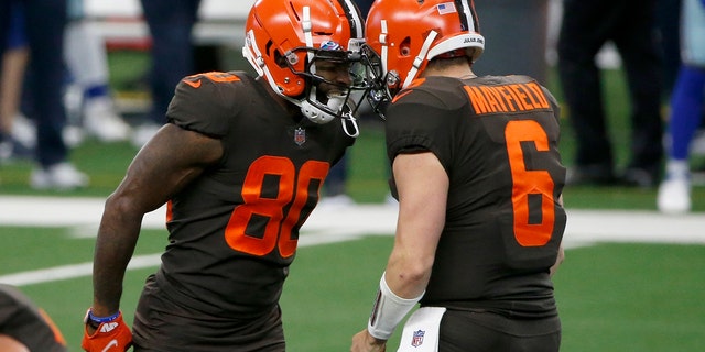 Cleveland Browns wide receiver Jarvis Landry (80) and quarterback Baker Mayfield (6) celebrate after Landry threw a touchdown pass to wide receiver Odell Beckham Jr. in the first half of an NFL football game against the Dallas Cowboys in Arlington, Texas, Sunday, Oct. 4, 2020. (AP Photo/Michael Ainsworth)